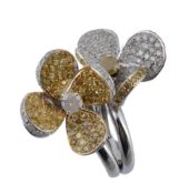 A diamond flower head ring, the two flower heads set throughout with brilliant cut diamonds and