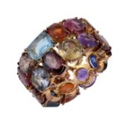 A multi gem set ring, the band set throughout with vari cut gemstones, including, sapphire, yellow