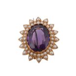 A Late Victorian amethyst and half pearl brooch, circa 1900, the central oval shaped amethyst in a
