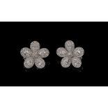 A pair of diamond flower head ear clips, set throughout with brilliant cut and pear shaped