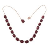 A Georgian garnet necklace, circa 1820, composed of oval shaped flat cut foil backed garnets in