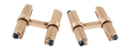 A pair of French sapphire cufflinks, the reeded batons set with a circular shaped cabochon sapphire