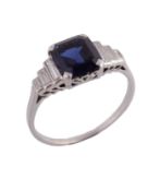 A sapphire and diamond ring, the central rectangular shaped sapphire in a four claw setting between