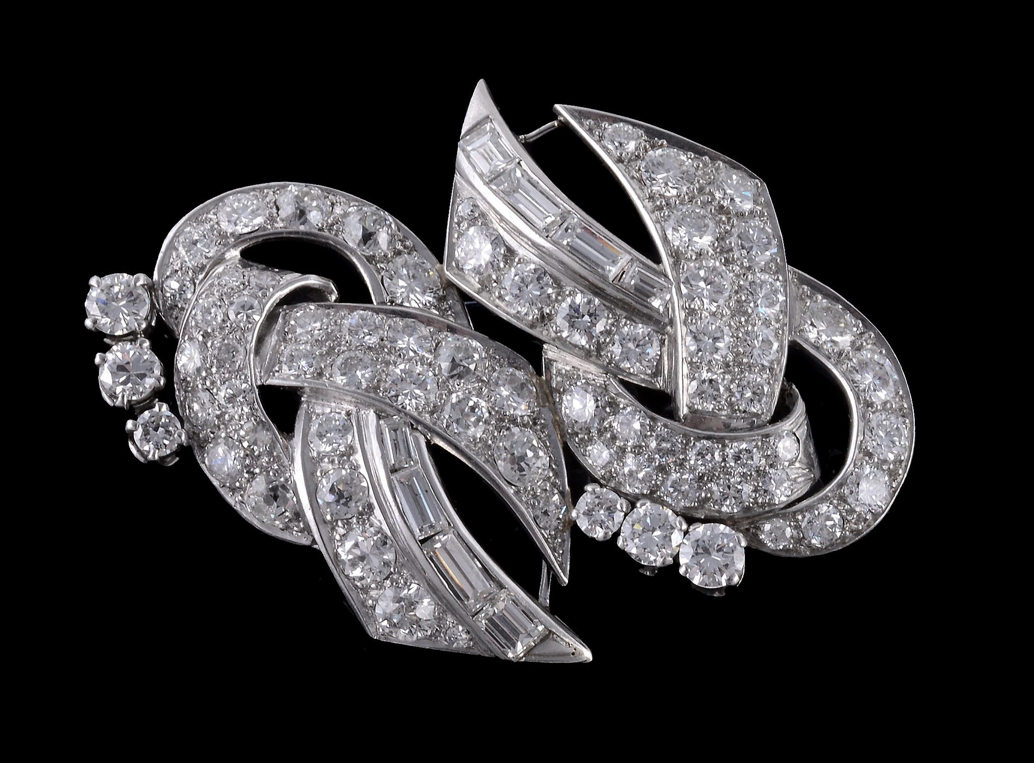 A 1950s diamond scroll brooch , the pierced scrolled panel set with brilliant and baguette cut