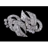 A 1950s diamond scroll brooch , the pierced scrolled panel set with brilliant and baguette cut