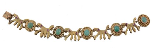 A fancy link emerald and ruby bracelet, the stylised dog shaped links with round cut ruby accents,