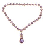 A Regency amethyst necklace, circa 1830, composed of graduating circular shaped amethysts within