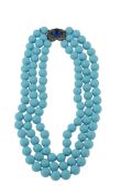 A reconstituted turquoise necklace, the three stranded necklace composed of polished reconstituted