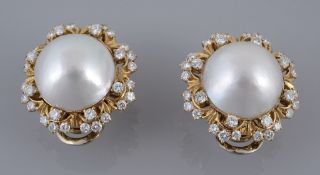 A pair of diamond and mabe pearl ear clips, the central mabe pearls within a pierced lobed diamond