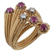 A ruby and diamond cross over ring, set with brilliant cut diamonds and circular shaped rubies on a