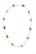 A multi gem necklace, the necklace with oval cut amethysts, citrines, peridots and an aquamarine,