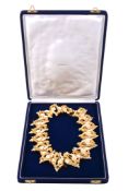 A gold and ivory necklace by Gubelin, circa 1972, composed of interlocking abstract gold colour and