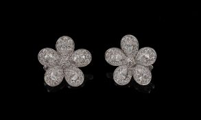 A pair of diamond flower head ear clips, the flower heads set throughout with brilliant cut