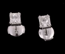 A pair of diamond single stone ear studs, set with a rectangular shaped diamond, approximately 1.10