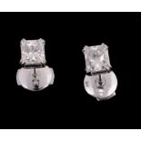 A pair of diamond single stone ear studs, set with a rectangular shaped diamond, approximately 1.10