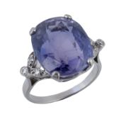 A purple sapphire ring, the oval shaped purple sapphire, estimated to weigh 14.00 carats, in a four