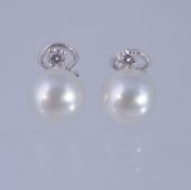 A pair of diamond and South Sea cultured pearl earrings, the cultured pearls with a brilliant cut