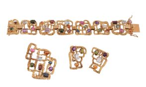 A multi gem set bracelet, composed of openwork textured links set with vari cut gemstones