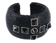 An onyx and diamond stingray cuff, set to the centre with pyramid shaped black onyxes, each within