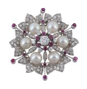 A diamond ruby and cultured pearl flower head brooch, the diamond and ruby cluster centre to
