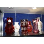 A quantity of decorative ceramics and glassware to include a cranberry glass jug, other coloured