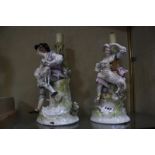 A pair of Sitzendorf figural candlesticks, 31cm high, (AF)