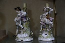 A pair of Sitzendorf figural candlesticks, 31cm high, (AF)