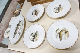 A French porcelain part fish service, to include one serving dish and eight plates.