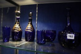An assortment of 19th Century and later English blue glass to include decanters, bottles etc