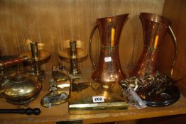 A set of brass postal scales with weights, copper graduated milk jugs, brass candlesticks and