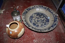 An Oriental charger, with crackle glaze, 39cm in diameter (AF) a delft style tankard and a slip-