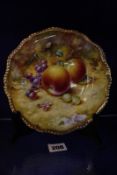 A Royal Worcester cabinet plate, gilt rim with hand painted fruit, signed S.Wood, 20cm