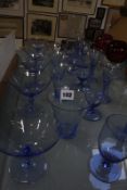 A quantity of blue tinted drinking glasses and other coloured glass