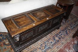 A Victorian carved triple panel chest 138cm wide