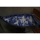 A Japanese blue and white boat shaped dish, decorated with landscape, 30cm long