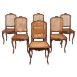A set of six French walnut and canework dining chairs  A set of six French walnut and canework