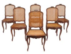 A set of six French walnut and canework dining chairs  A set of six French walnut and canework