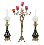 A pair of Continental porcelain and gilt metal mounted table oil lamps  A pair of Continental