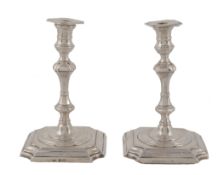 A pair of Edwardian silver tapersticks by George Unite & Sons, Birmingham 1902, in George I style,