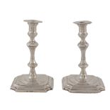 A pair of Edwardian silver tapersticks by George Unite & Sons, Birmingham 1902, in George I style,
