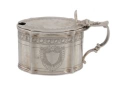 A late Victorian silver shaped oval mustard pot by Charles Stuart Harris, London 1899, engraved in