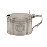 A late Victorian silver shaped oval mustard pot by Charles Stuart Harris, London 1899, engraved in