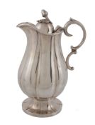 A George IV silver covered jug, maker's mark AT, London 1829, with an acorn finial to the dome