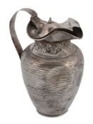 An Edwardian silver ovoid covered jug by Edward Barnard & Sons, London 1907, with a dome centred