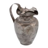 An Edwardian silver ovoid covered jug by Edward Barnard & Sons, London 1907, with a dome centred