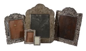 Two South American silver coloured mounted easel photograph frames, the larger with indistinct