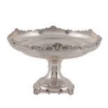 A silver circular comport, maker's mark rubbed, London 1921, with a shell and scroll shaped rim,