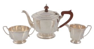 An Art Deco silver three piece tea service, the tea pot and cream, jug by Adie Bros, the sugar