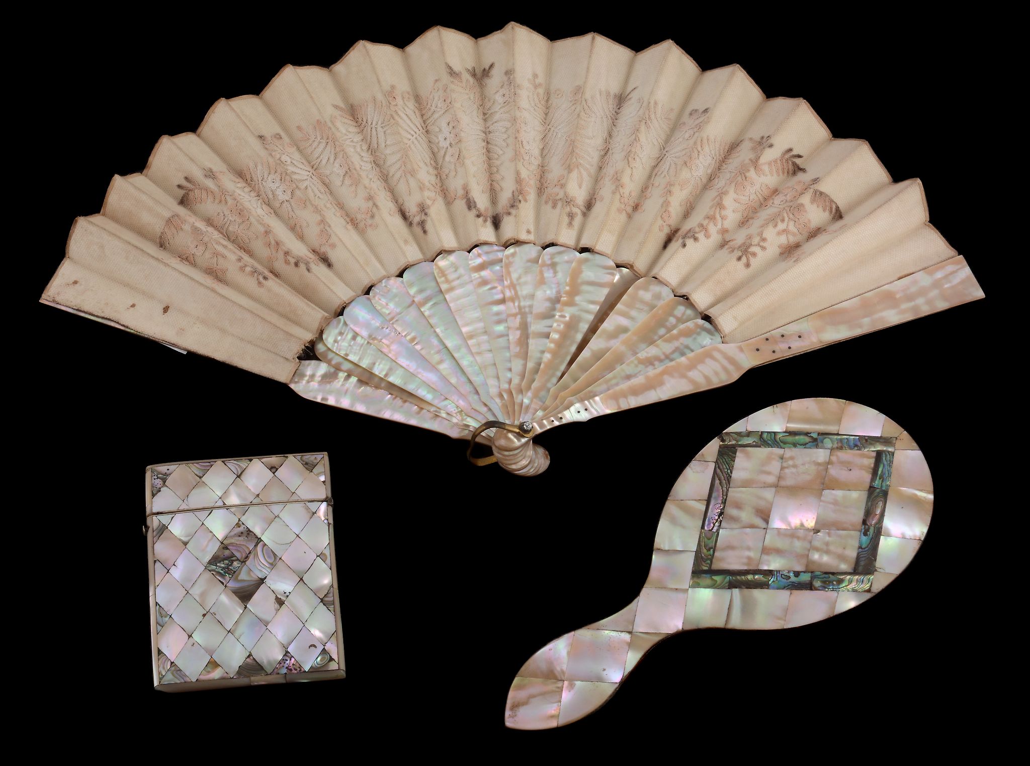 A Victorian mother of pearl and abalone lozenge veneered hand mirror, 22.5cm (8 3/4in) long; a