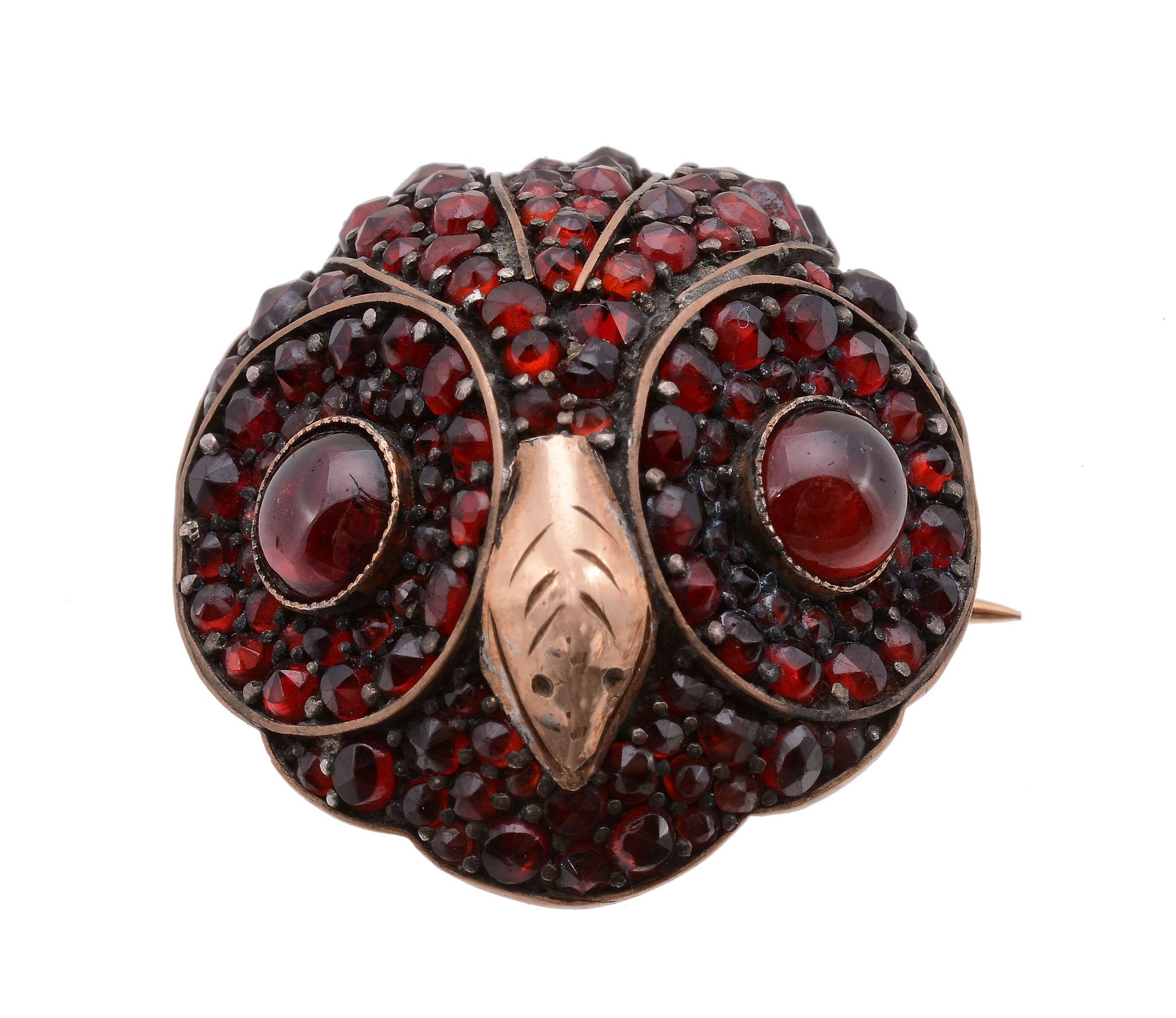 A garnet set owl brooch, the circular brooch designed as an owl head, set throughout with circular